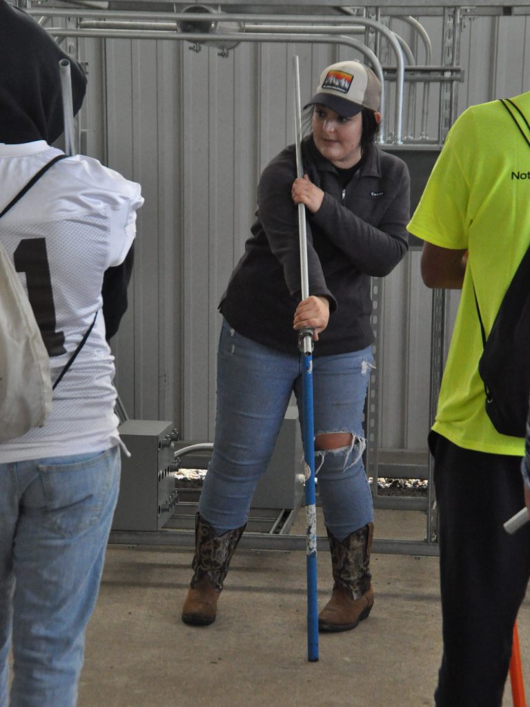 An apprentice teaches students to bend conduit at an expo.