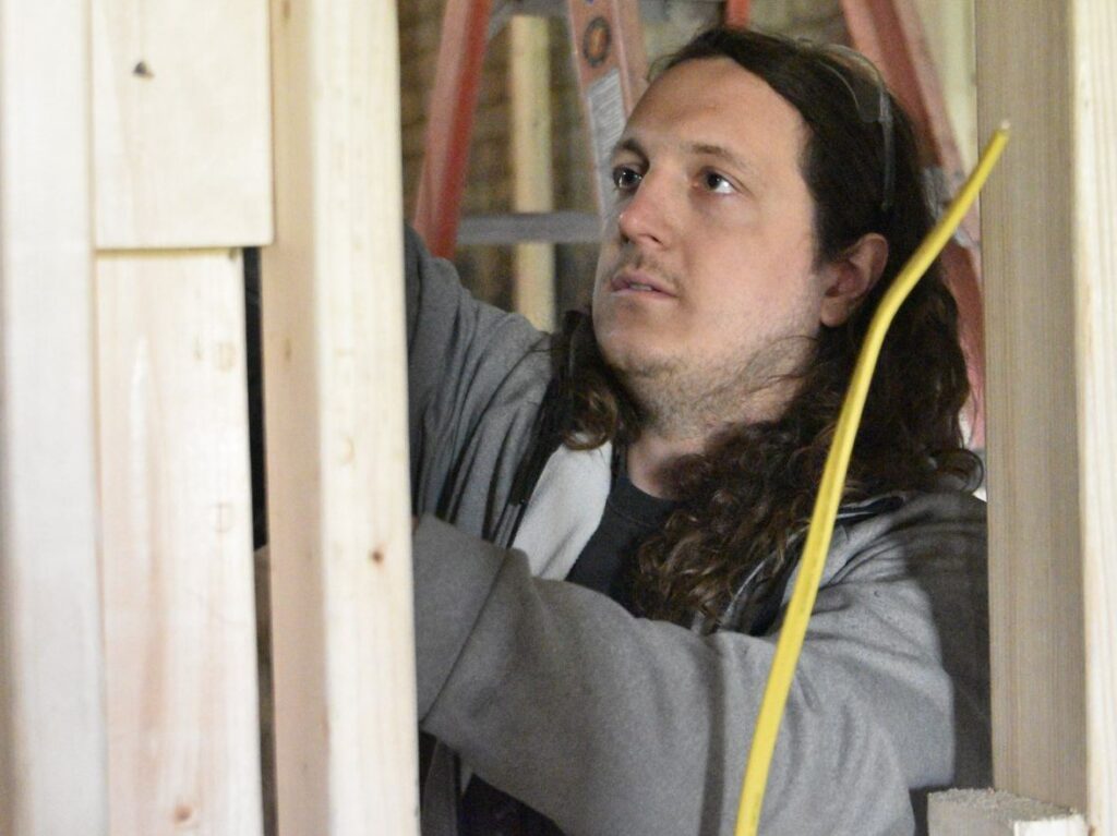 Eric Inskeep installs wire.