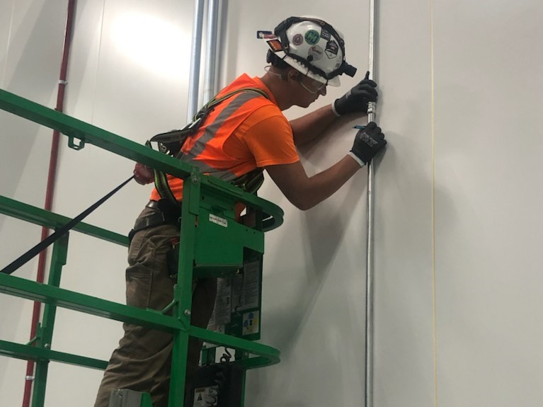 Electrician working at Ultium Cells plant early in the project.