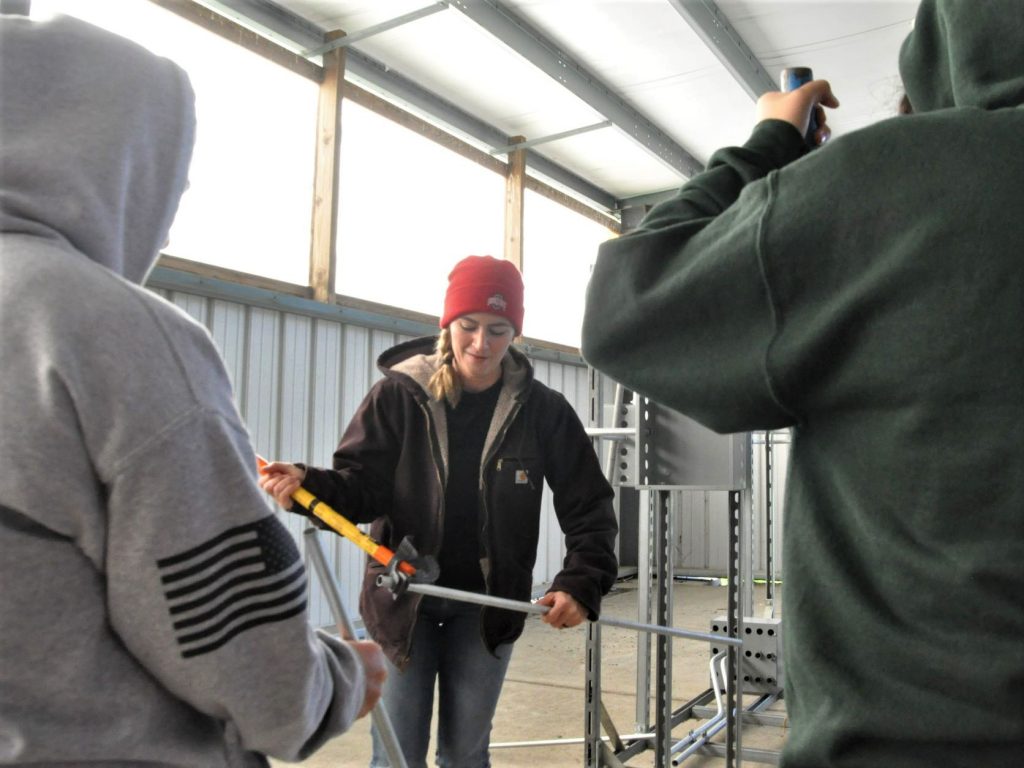 Apprentice bends conduit at trades expo.