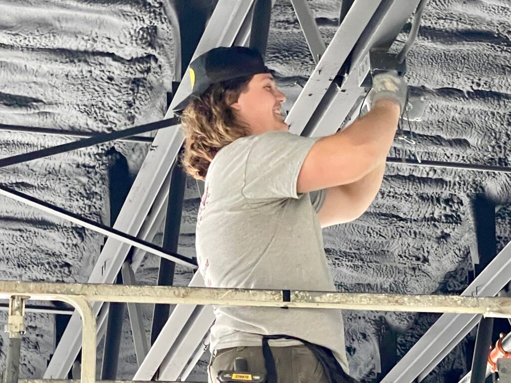 PJ Beres, of Boot Electric, putting in overhead lighting.