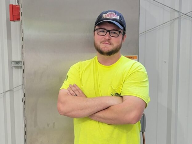 Ahren Peplow stands with his work.