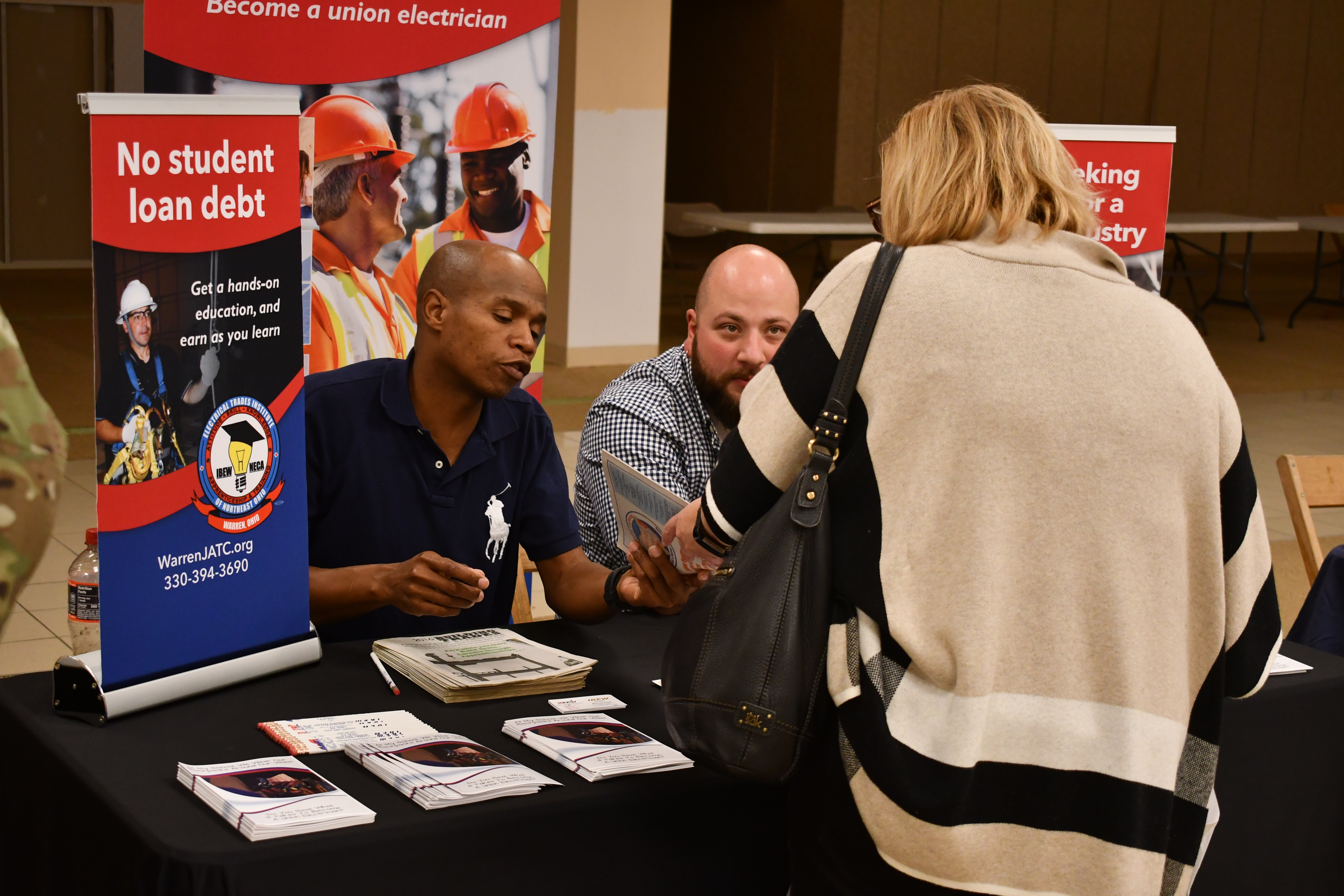 electricians discuss apprenticeships with high school students